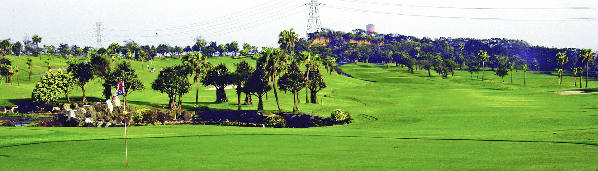 wide panoramic landscape featuring a lush green field