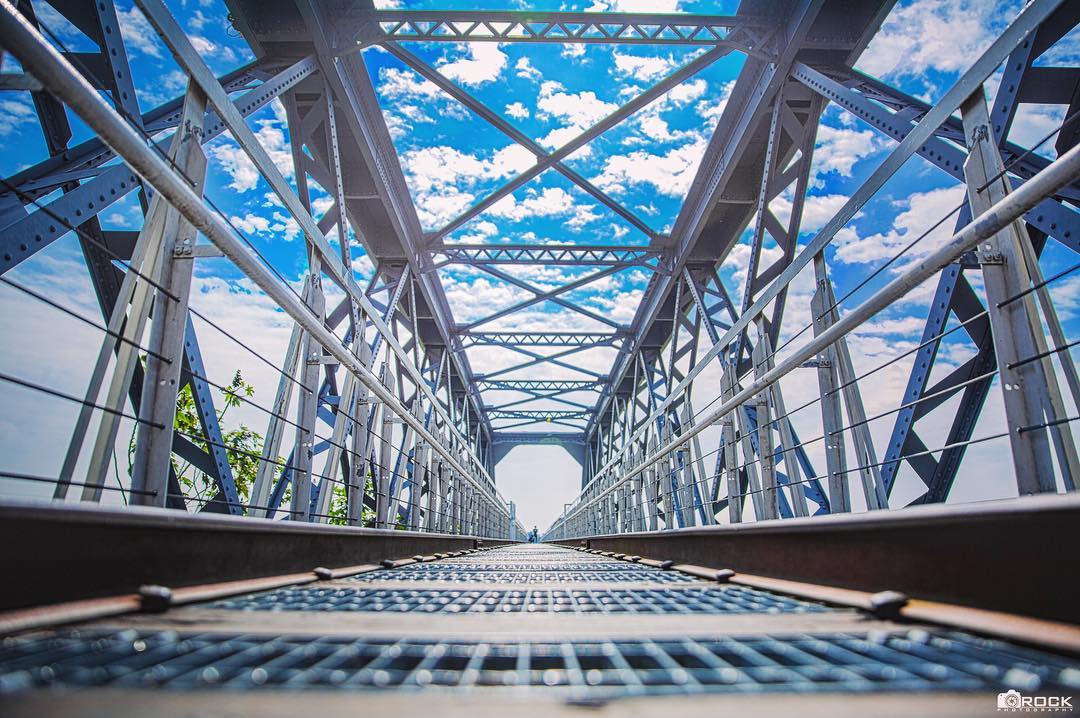 View of a steel truss bridge from a low angle