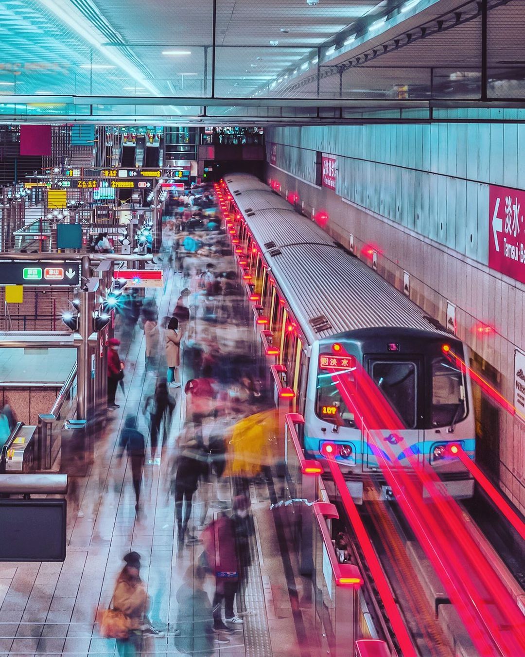 A busy Taiwan metro station with commuters boarding a train during peak hours
