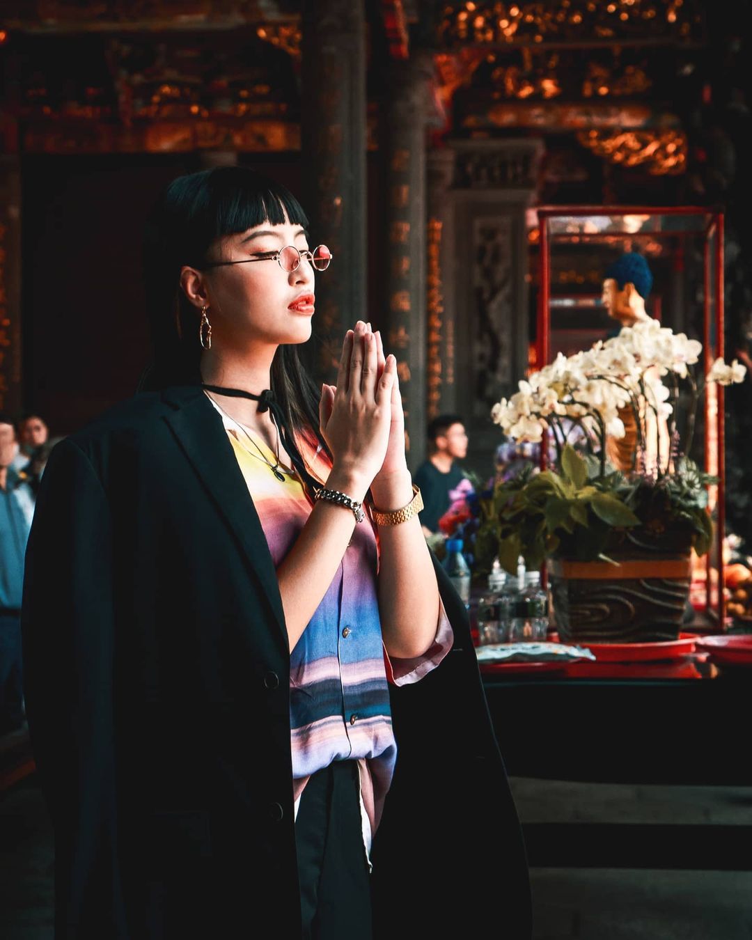 A woman praying at a traditional temple in Taiwan