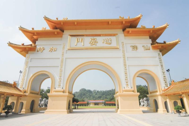 A large, ornate archway with golden and is flanked by lion statues