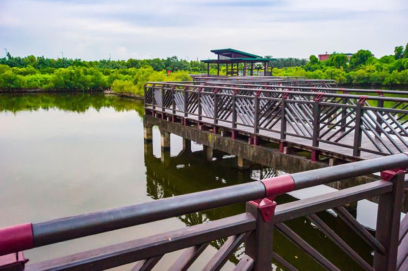 Wooden walkway extends over a calm lake