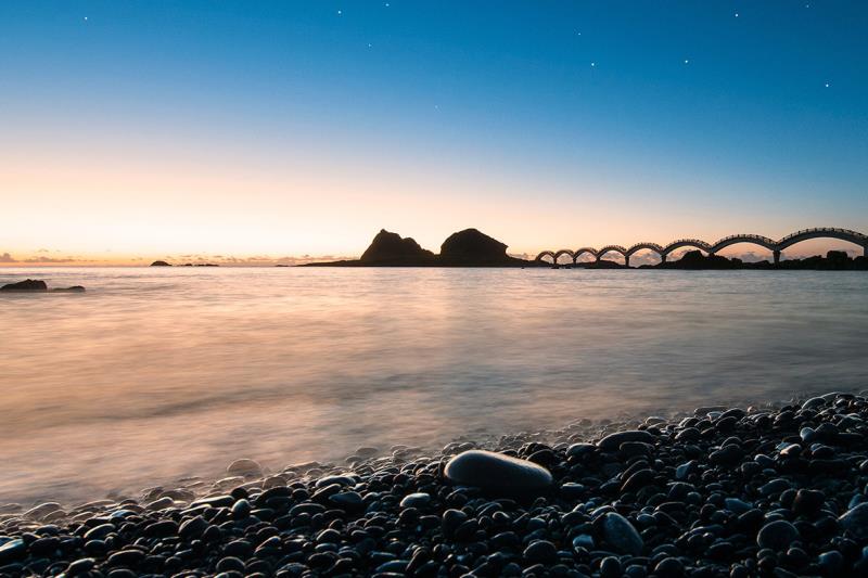 Pebble beach at twilight with a calm sea