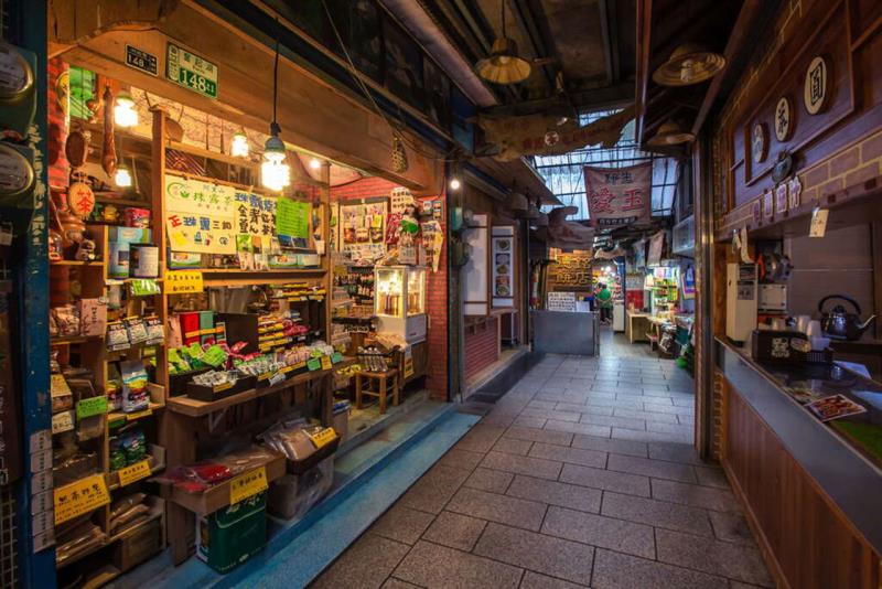 A narrow, cozy market alleyway with warm lighting