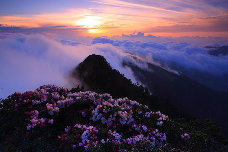 Sunset view over misty mountains with vibrant clouds
