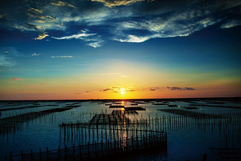 Sunset over a serene body of water