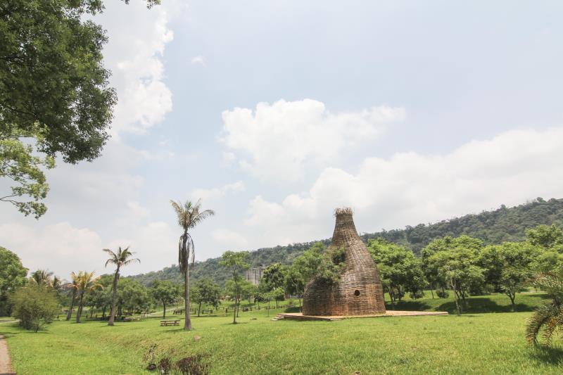 A ancient stone structure stands amid lush green grass