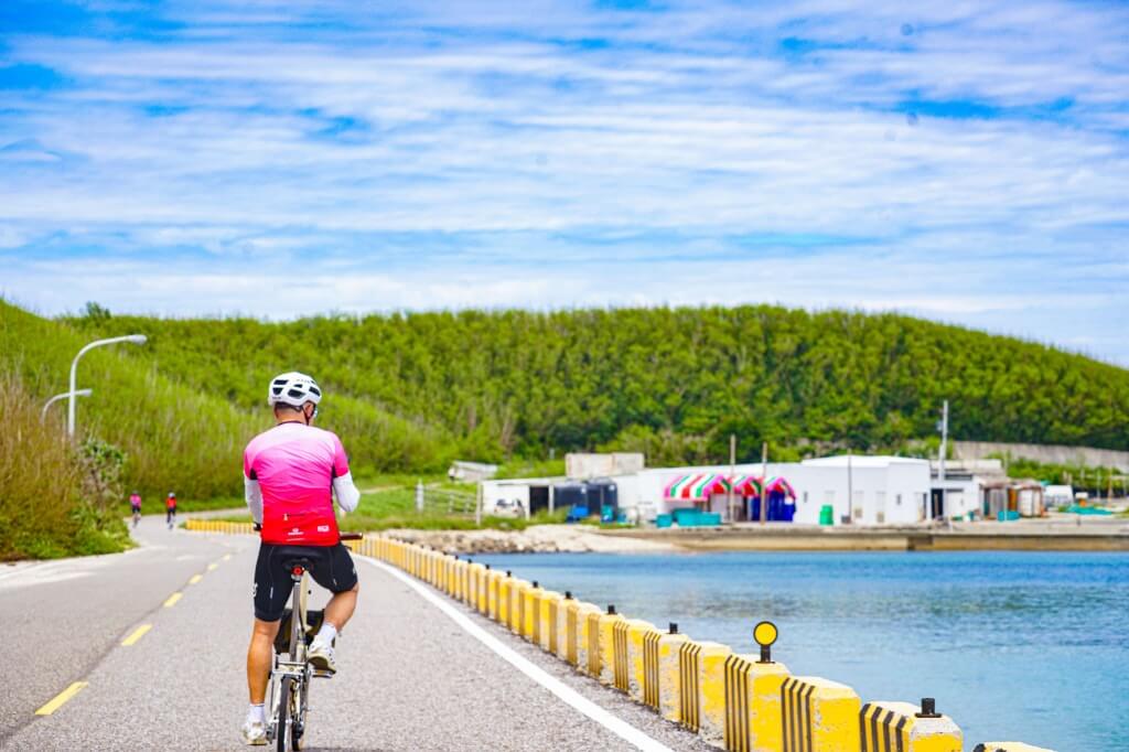 cyclist riding along a coastal path or harbor side