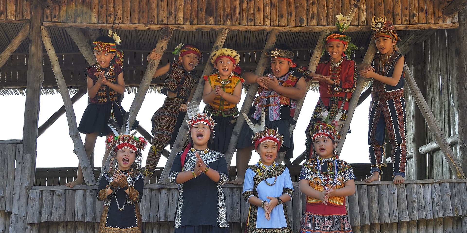 indigenous Rungus community in traditional attire inside or near a traditional longhouse in Sabah
