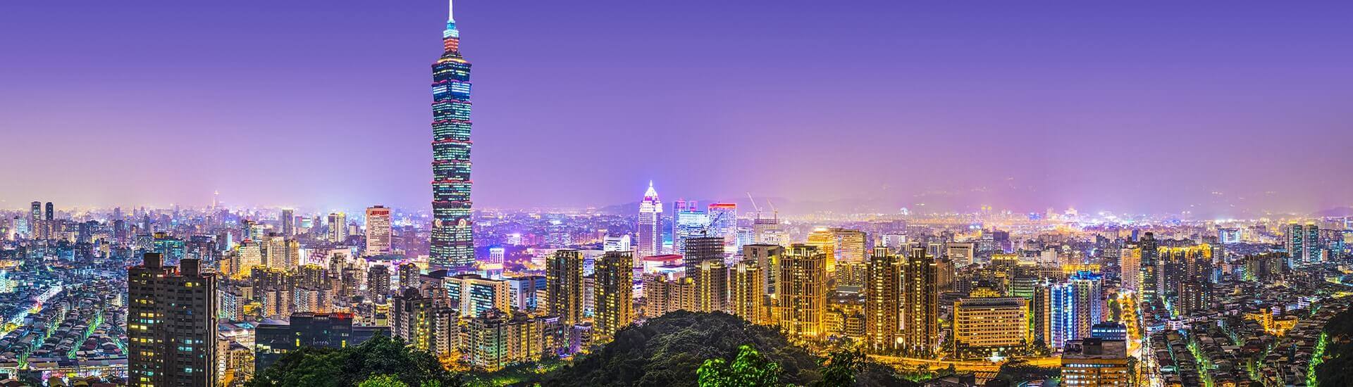Picturesque nature view featuring Taipei's surrounding green hills and blue sky.
