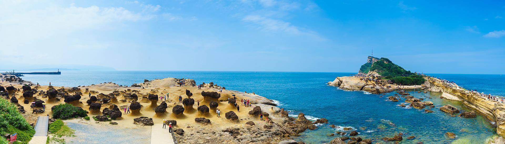 Sunny coastal beach view with clear blue tropical ocean waters in Taiwan.