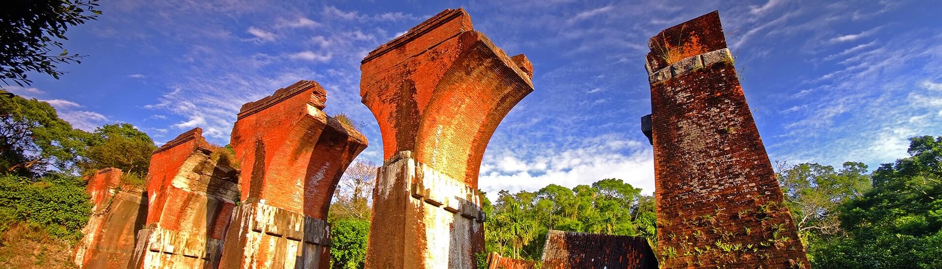 Historic Longteng Broken Bridge red brick arch ruins surrounded by hills in Miaoli.