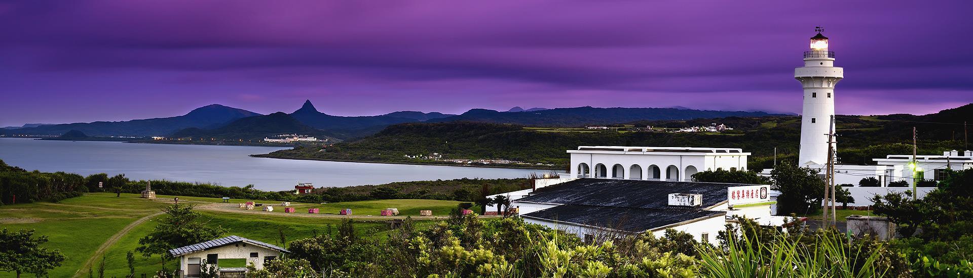 Eluanbi Lighthouse surrounded by lush coastal foliage in Kenting, Pingtung.
